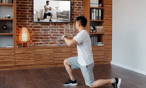 Man streaming workout routine to home, meant to signify Netflix.