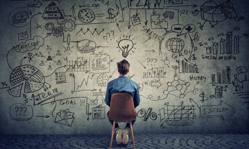 Back view of man coming up with business plan to illustrate methods of growing your business based on perspective.