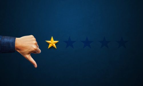 Hand of client giving one-star review. Example of negative reviews and how businesses can handle them