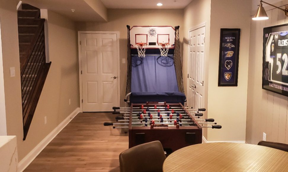 Gramophone Revitalizes Basement as a Sports-Themed Entertainment Room, slide 1