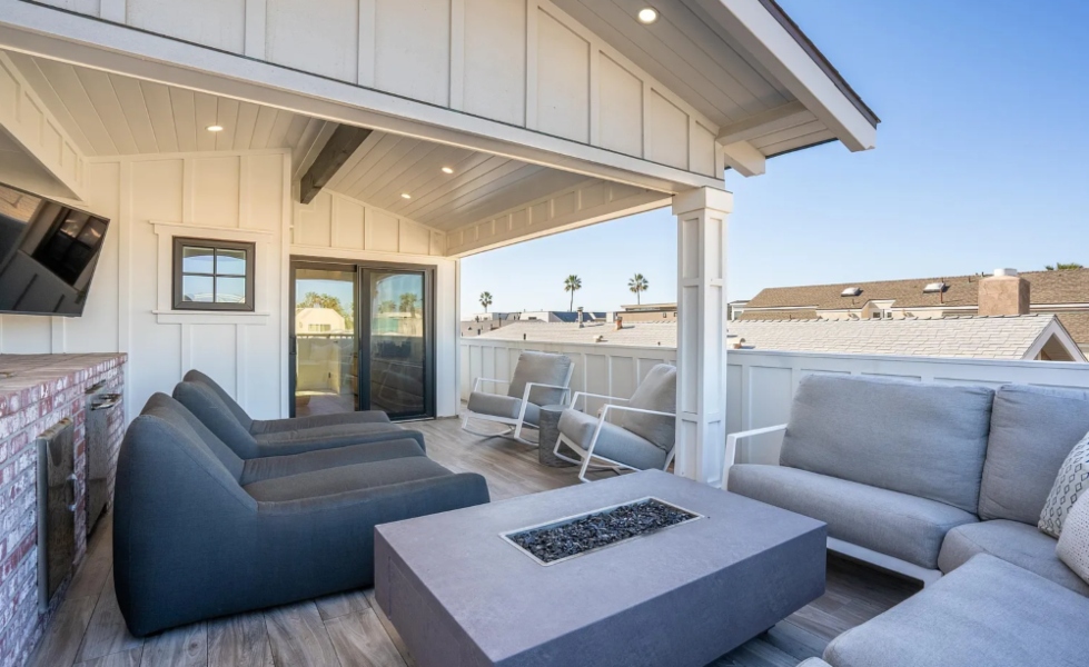 Outdoor terrace with firepit and corner mount TV Pacific Beach California