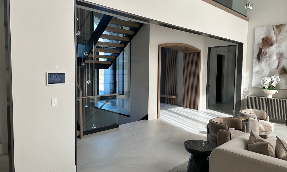 Foyer/living room space with modern Control4 smart home control panel in view