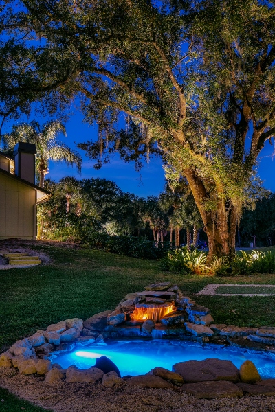 Outdoor lighting display with mixed color temperatures from warmer uplights to cooler downlights