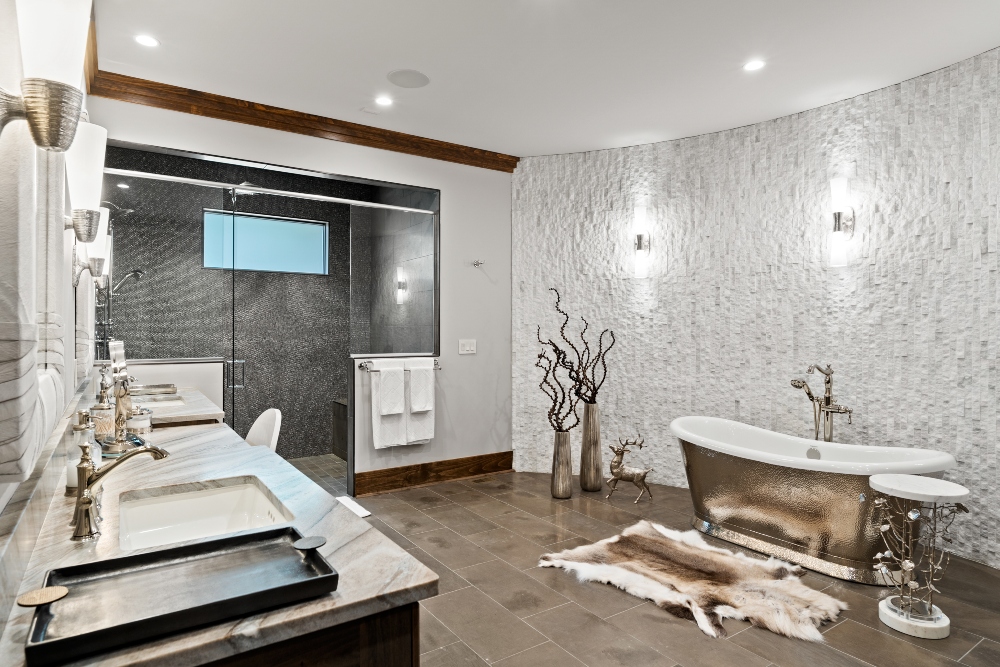 Cool modern bathroom with glowing wall sconces and natural flowing sculptures of branches against the wall